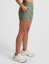 green mid-rise 3" inseam shorts with pockets.